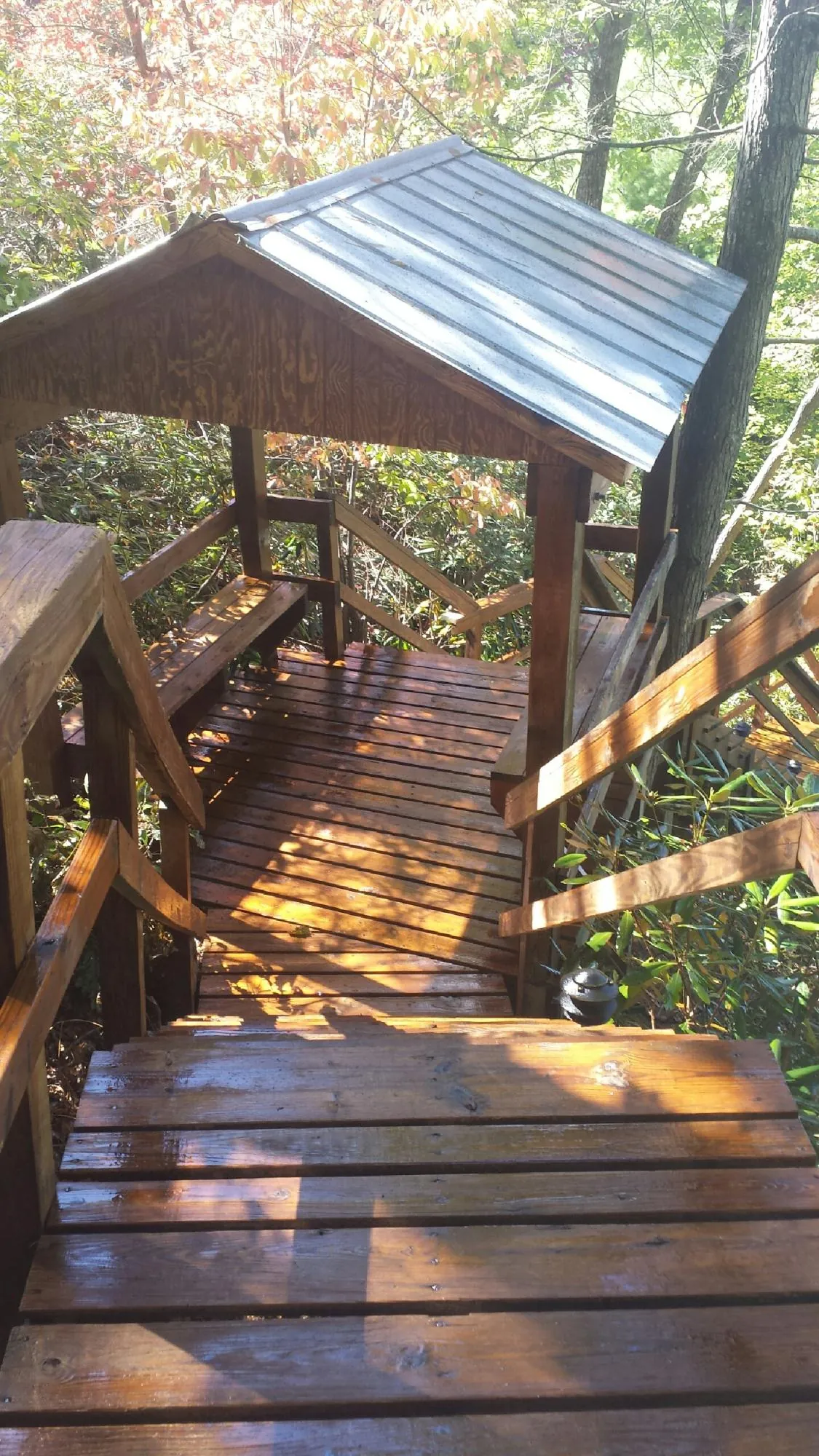 Freshly stained wood walkway and covered shelter with a metal roof in Cocolamus